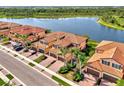 Stunning aerial view of townhomes with tile roofs, paver driveways, and lush landscaping at 10789 Tarflower Dr # 202, Venice, FL 34293
