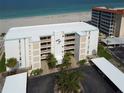 Bahia Mar condo building with white facade, balconies, and convenient covered parking at 1100 Tarpon Center Dr # 503 5C, Venice, FL 34285