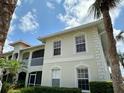 Two story condo showcases well-maintained landscaping, white trim, and a private screened-in balcony at 1204 L Pavia Blvd # 1204, Venice, FL 34292