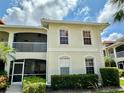 Condominium building showing manicured landscape, white trim, with a private screened-in balcony at 1204 L Pavia Blvd # 1204, Venice, FL 34292