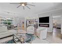 Open-concept living room with a modern fireplace and designer furnishings at 12871 Cinqueterre Dr, Venice, FL 34293