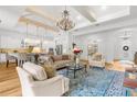 Open living room boasts a chandelier, hardwood floors, and access to the kitchen at 13280 Campanile Ct, Venice, FL 34293