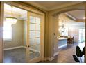 Bright foyer leading to a modern kitchen with a large island and breakfast nook, adjacent to a living area at 136 Positano Trl, Nokomis, FL 34275