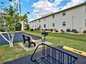 Park-like setting with benches, barbeque grills, and bike racks at 1531 Placida Rd # 202 Building 9, Englewood, FL 34223