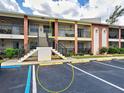 Close-up of the condo building highlighting the private balcony and stair access at 1531 Placida Rd # 202 Building 9, Englewood, FL 34223