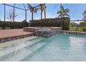 Sparkling pool with in-ground spa features tile detail and a screened lanai, perfect for outdoor entertaining at 15336 Spanish Point Dr, Port Charlotte, FL 33981