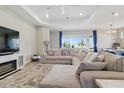 Spacious living room with a large sectional couch, bright windows and an adjacent kitchen area at 15963 Crofton Springs Way, Port Charlotte, FL 33953