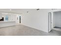 Open-concept living room features tile floors and ample natural light, with access to kitchen at 17595 Opal Sand Dr # 205, Venice, FL 34293
