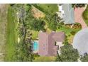Aerial view of a home showcasing the large lot, screened-in pool, and lush landscaping at 188 Grand Oak Cir, Venice, FL 34292