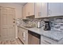 Cozy kitchen features stainless steel appliances, granite countertops, stylish backsplash, and shaker cabinets at 200 The Esplanade N # C19, Venice, FL 34285