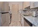 Charming kitchen features stainless steel appliances, granite countertops, modern backsplash, and ample cabinets at 200 The Esplanade N # C19, Venice, FL 34285