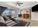 An open-concept living area boasts a comfortable sofa, open kitchen, and access to a screened-in patio at 235 Base E Ave # 207, Venice, FL 34285