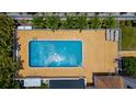 A top-down view of a refreshing outdoor swimming pool with a sun-soaked deck, perfect for relaxation at 235 Base E Ave # 207, Venice, FL 34285