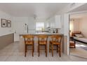 Eat-in kitchen and breakfast bar area with seating and a full view into the bedroom at 25050 Sandhill Blvd # 6A3, Punta Gorda, FL 33983