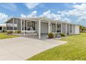 Lovely single-story home with a screened-in porch, covered parking, and beautifully maintained landscaping at 349 Mariner Dr, North Port, FL 34287