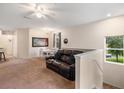Living room with ample seating, natural light, and ceiling fan at 3613 Parkridge Cir # 11-201, Sarasota, FL 34243