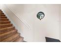 Carpeted staircase with decorative wall art at 3613 Parkridge Cir # 11-201, Sarasota, FL 34243