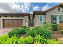 Charming home featuring manicured landscaping, a brick driveway, and an attached two-car garage at 4740 Royal Dornoch Cir, Bradenton, FL 34211