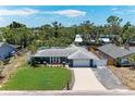 Sprawling property showcasing a well-maintained lawn, charming exterior, and a serene neighborhood setting at 5207 5Th Avenue Nw Dr, Bradenton, FL 34209