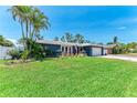 Inviting single-story residence with a lush green lawn and vibrant landscaping, offering curb appeal at 5207 5Th Avenue Nw Dr, Bradenton, FL 34209