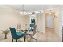 Light dining room with a glass table and a doorway to the kitchen and hallway at 708 Tamiami S Trl # 115, Venice, FL 34285