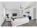 Bright and airy living room with stylish furniture, ceiling fan, and large windows for natural light at 711 Brenton Leaf Dr, Ruskin, FL 33570