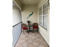 Balcony with seating and tile floor, overlooking manicured landscaping at 7201 L Pavia Blvd # 7201, Venice, FL 34292
