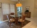Dining room with glass table and view into the Primary bedroom at 7201 L Pavia Blvd # 7201, Venice, FL 34292
