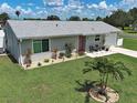 Charming single-story home featuring a manicured lawn and beautiful landscaping at 7505 Wexford St, North Port, FL 34287