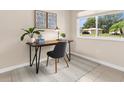 Bright office space with a modern desk setup with natural light from a window overlooking the outdoors at 7582 Lyncrest St, North Port, FL 34287
