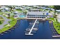 Aerial view of the community marina with boat slips and a clubhouse with a refreshing pool at 763 Lakeside Dr, North Port, FL 34287