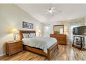 Comfortable bedroom with hardwood floors, ceiling fan, ensuite bath, and natural light at 1110 Southlake Ct, Venice, FL 34285