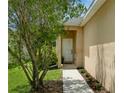 Inviting front entrance with a white door, landscaping and a cozy front porch at 11954 Tempest Harbor Loop, Venice, FL 34292