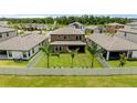 Spacious backyard featuring a well-maintained lawn, privacy fence, and three palm trees at 12617 Oak Hill Way, Parrish, FL 34219