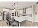 Modern kitchen featuring white cabinets, a large island with seating, and stainless steel appliances at 12617 Oak Hill Way, Parrish, FL 34219