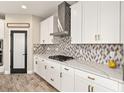 Gourmet kitchen featuring white cabinets, granite countertops, gas range, and stainless steel hood at 12617 Oak Hill Way, Parrish, FL 34219