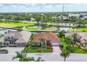 Beautiful aerial view of home showing the tile roof, landscaping, and golf course community at 1345 Reserve Dr, Venice, FL 34285