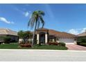 Attractive single-story home with a tile roof, two-car garage, and beautifully landscaped front yard at 1345 Reserve Dr, Venice, FL 34285