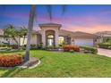 Charming single-story home featuring a tile roof, manicured landscaping, and a welcoming front entrance at 1345 Reserve Dr, Venice, FL 34285