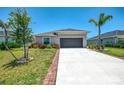 Well-maintained single-Gathering home with a two-car garage and lush landscaping at 137 Hercules Dr, Rotonda West, FL 33947