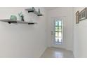 Hallway featuring decorative shelving and a door with decorative glass at 137 Hercules Dr, Rotonda West, FL 33947