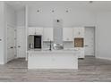 Modern kitchen with stainless steel appliances, white cabinets, and a large island at 137 Mariner Ln, Rotonda West, FL 33947