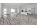 Bright open-concept living room with wood floors and modern lighting at 137 Mariner Ln, Rotonda West, FL 33947