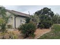Well-maintained single-story home with rock landscaping, mature shrubbery, and healthy green lawn at 14261 Palm Ter, Port Charlotte, FL 33953