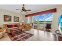 Living room with comfortable seating and a sliding door to a balcony with serene water views at 157 Tampa E Ave # 305, Venice, FL 34285