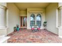 Charming front porch featuring brick pavers and seating area at 20169 Cristoforo Pl, Venice, FL 34293