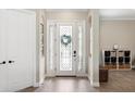 Bright foyer showcasing a decorative front door with sidelights and tile flooring at 20443 Cristoforo Pl, Venice, FL 34293