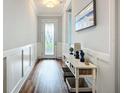 Hallway with a decorative table and a glass door entrance at 20749 Swallowtail Ct, Venice, FL 34293