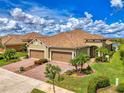 Beautiful home with well-maintained landscaping, paver driveway, and a two-car garage at 21641 Winter Park Ct, Venice, FL 34293