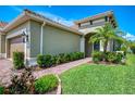 Charming front entrance with brick walkway, manicured landscaping, and classic exterior lighting at 21641 Winter Park Ct, Venice, FL 34293